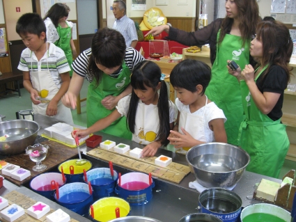 Local children making wax candles - photo by Rob McFarland